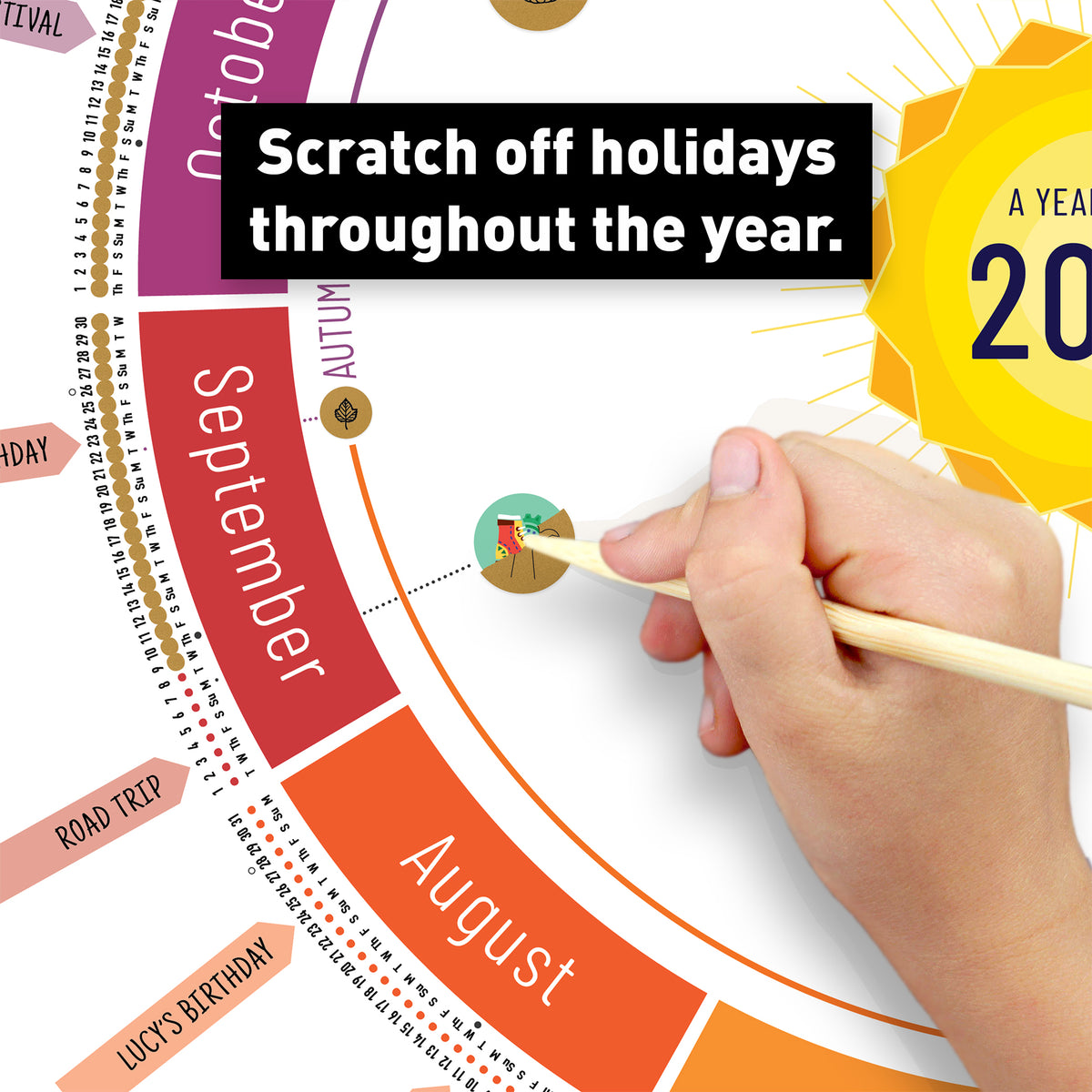 Hand scratching off a holiday icon on the White Year Round Calendar (With Holidays version) to reveal colorful artwork underneath.