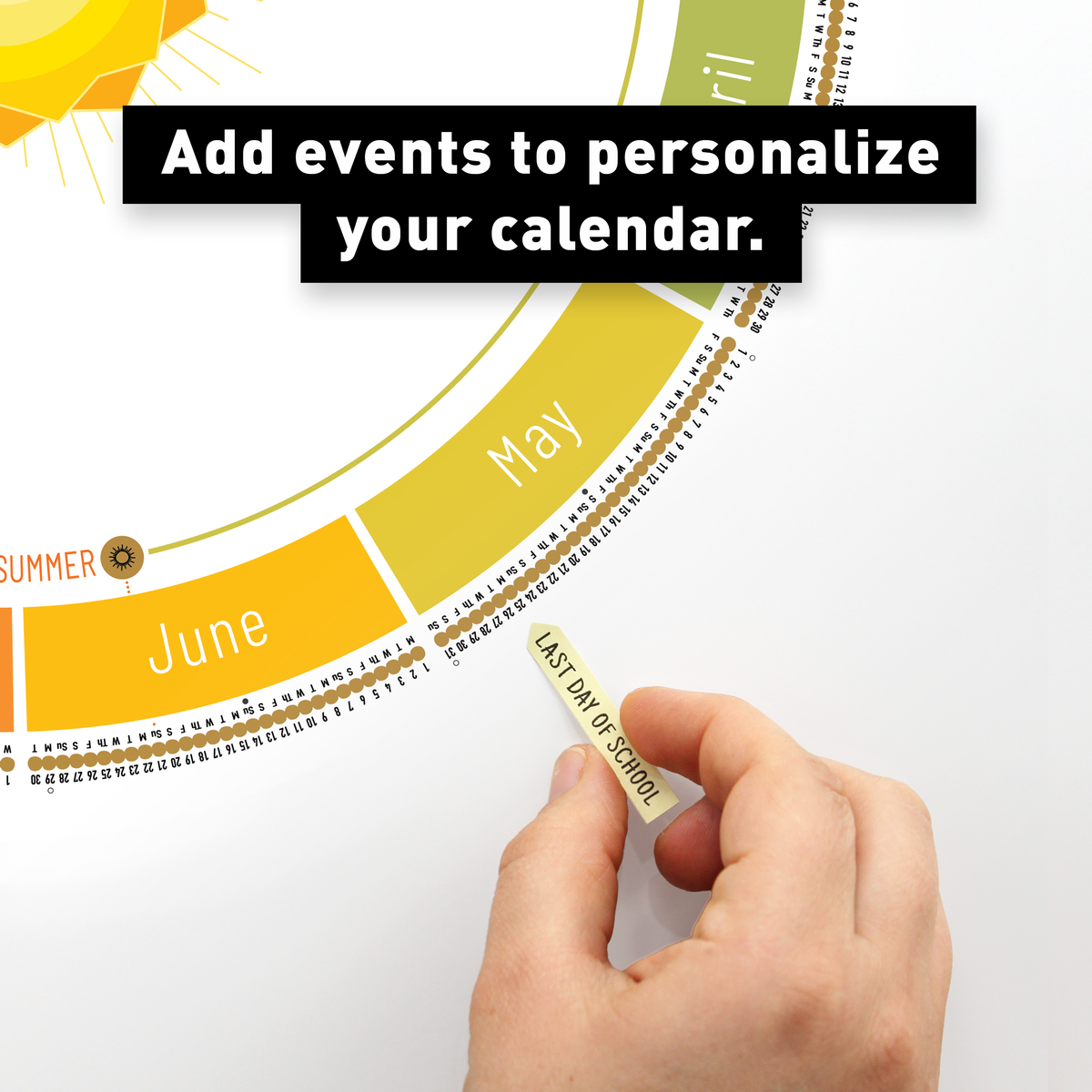 Hand adding a sticker flag to personalize the White Year Round Calendar with important events.